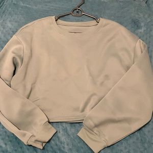 Crewneck sweatshirts. One teal, one darker blue.